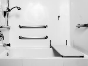  Bathtub shower with grab bars and a fold down seat. 