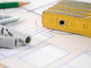 Close-up view of pencils and rulers over the blueprints of a home.