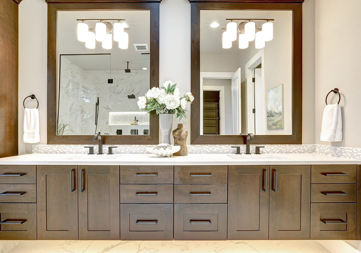 image of a bathroom double vanity with cabinets and mirrors